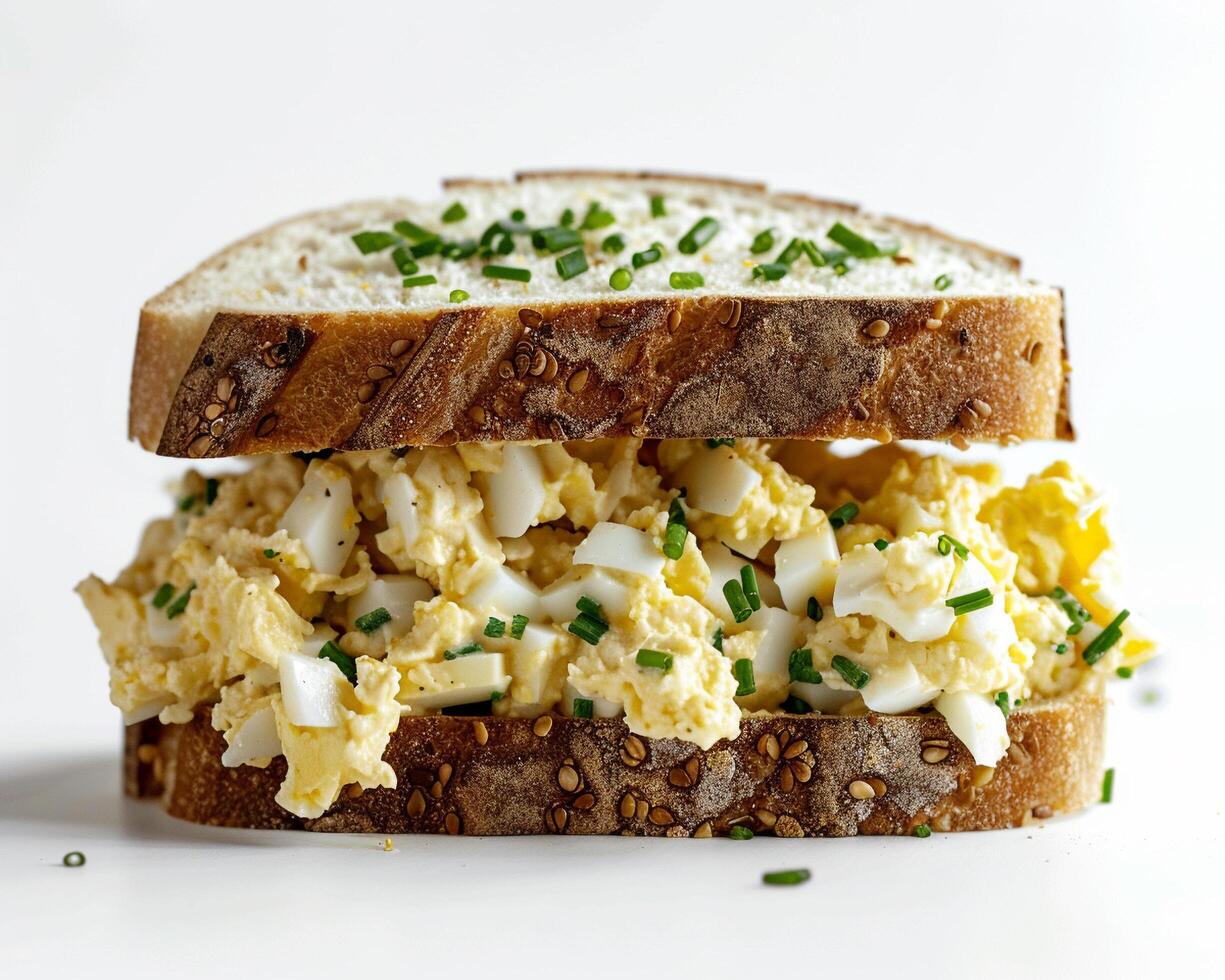 a sandwich with scrambled eggs on top photo
