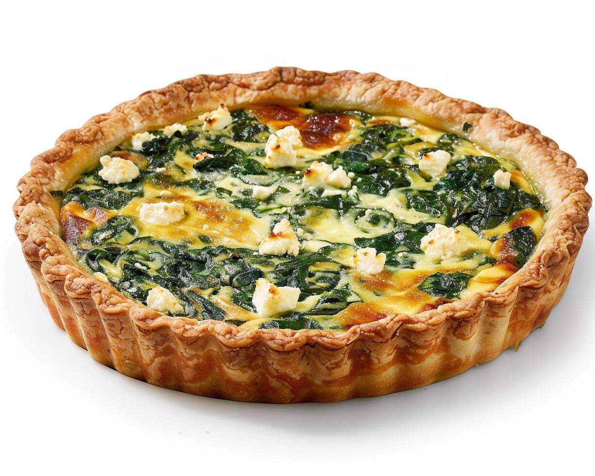 a quiche with spinach and cheese on a white surface photo