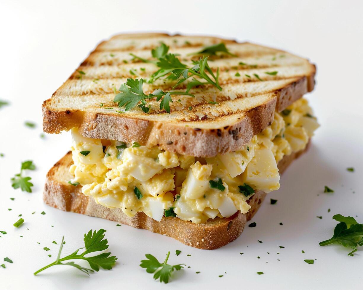 a sandwich with eggs and herbs on it photo
