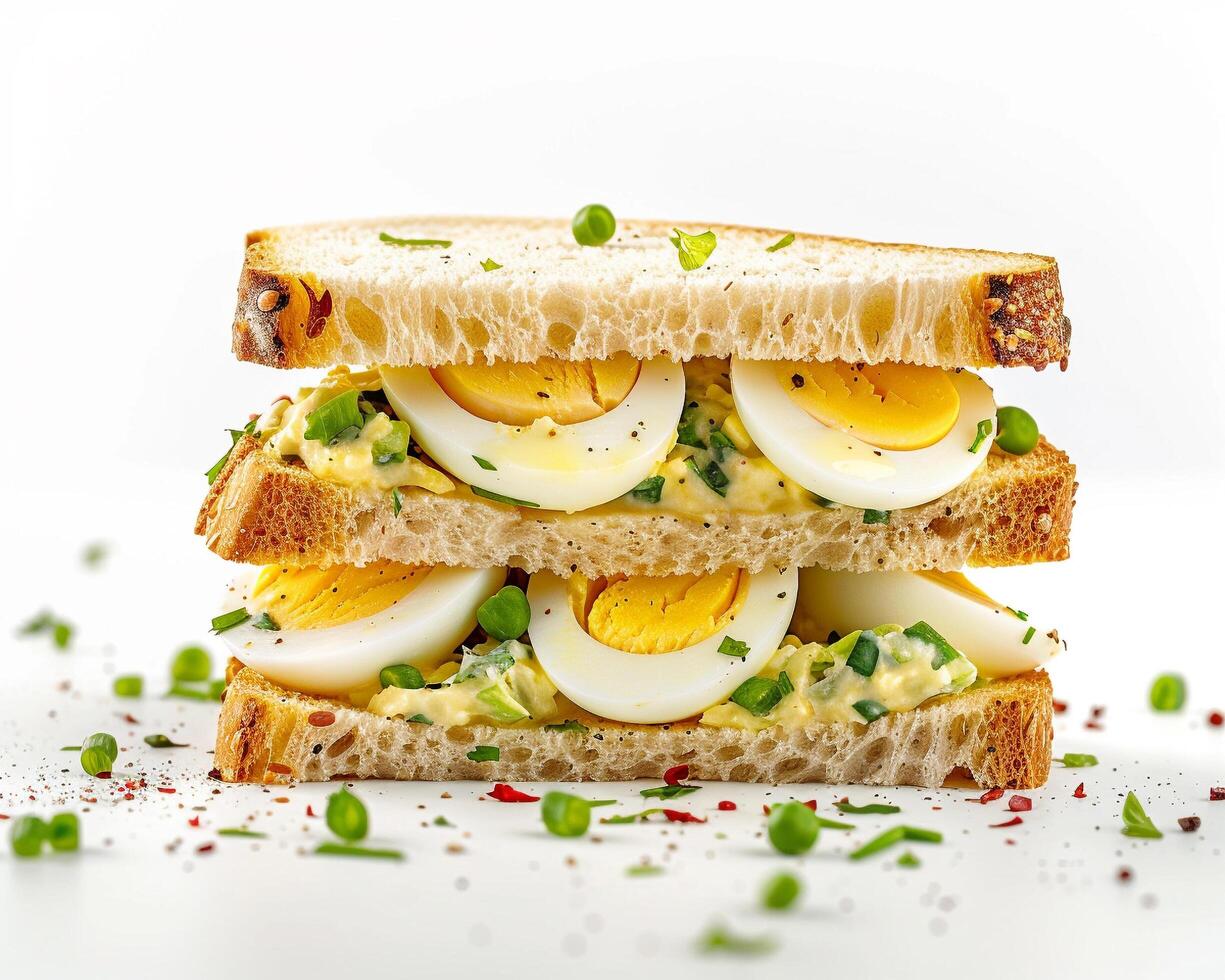 a sandwich with hard boiled eggs and green onions photo