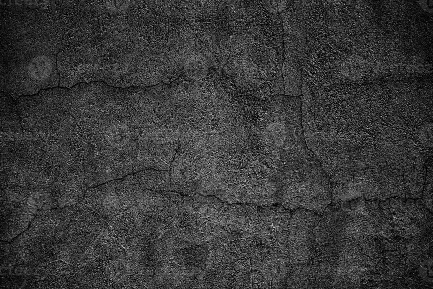 gloomy concrete wall with cracks. destroyed black slab of slab photo