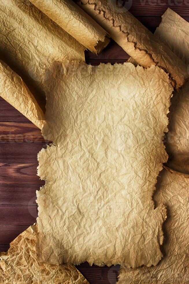 Crumpled scroll on wooden background, empty space for text photo