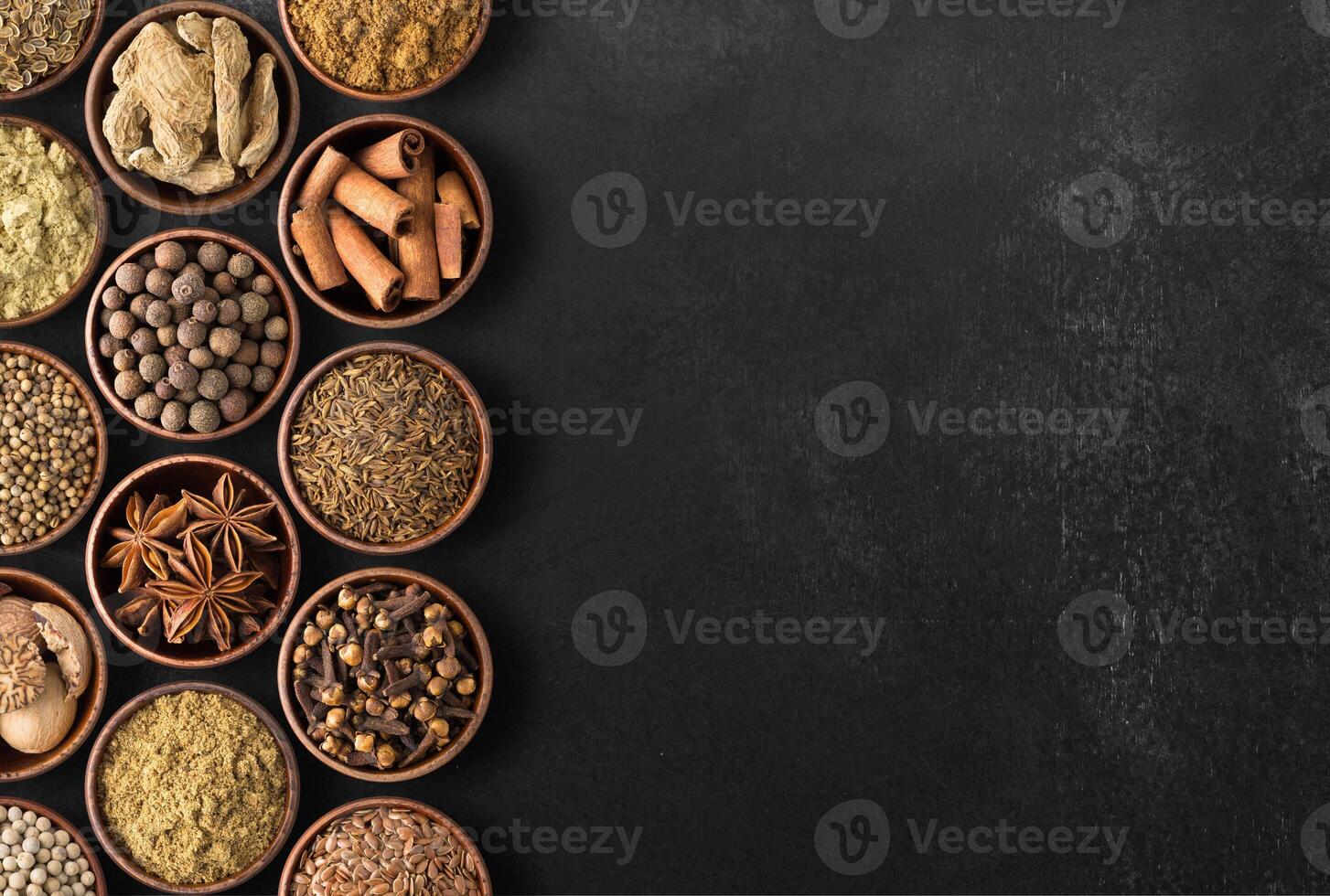 Spices over black table background. Top view of seasoning with free space photo