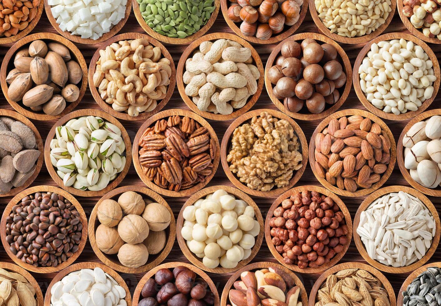 various nuts background, raw food in bowls, top view photo