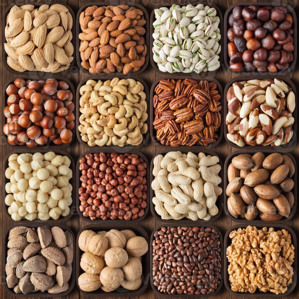 assorted nuts on wooden table background. composition organic food in square bowls, top view. photo