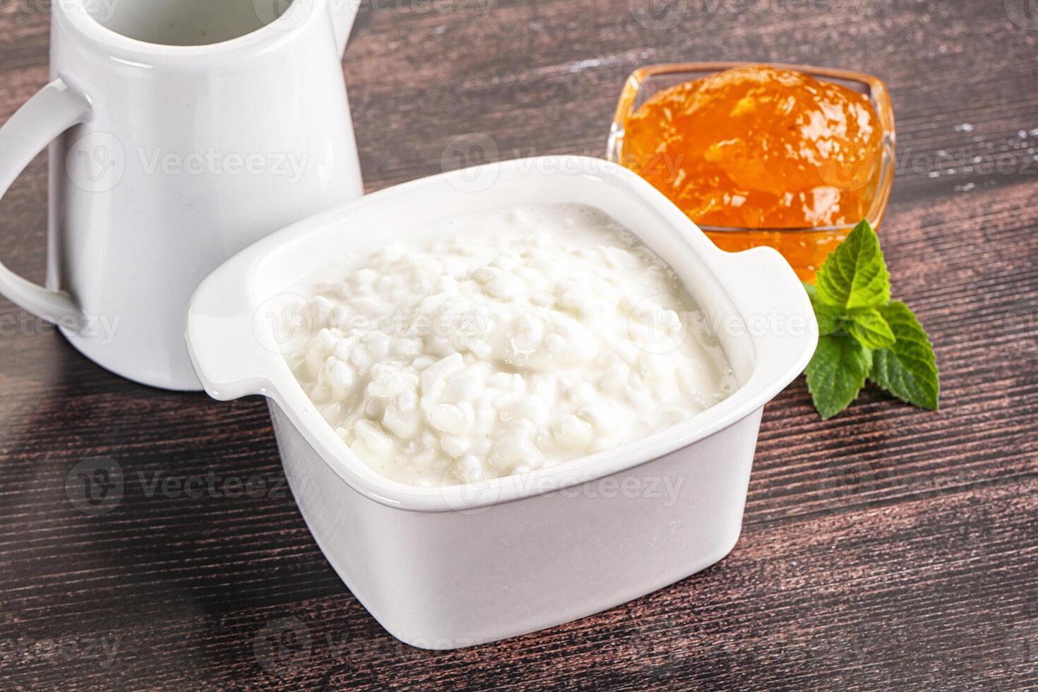 Grain curd with cream and jam photo