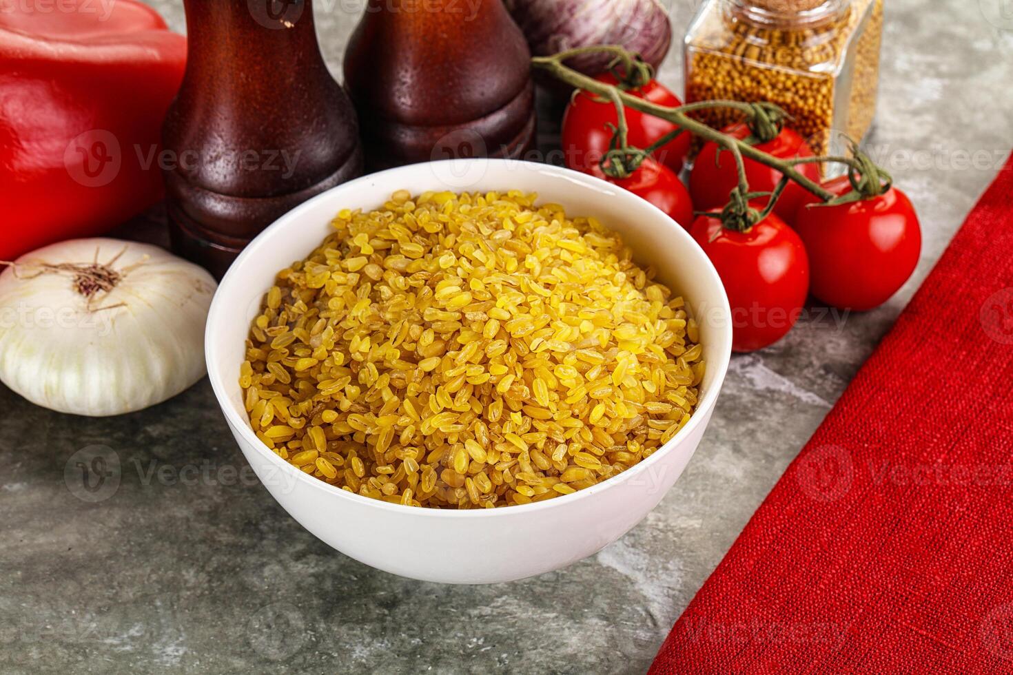 Dry wheat bulgur cereal heap photo