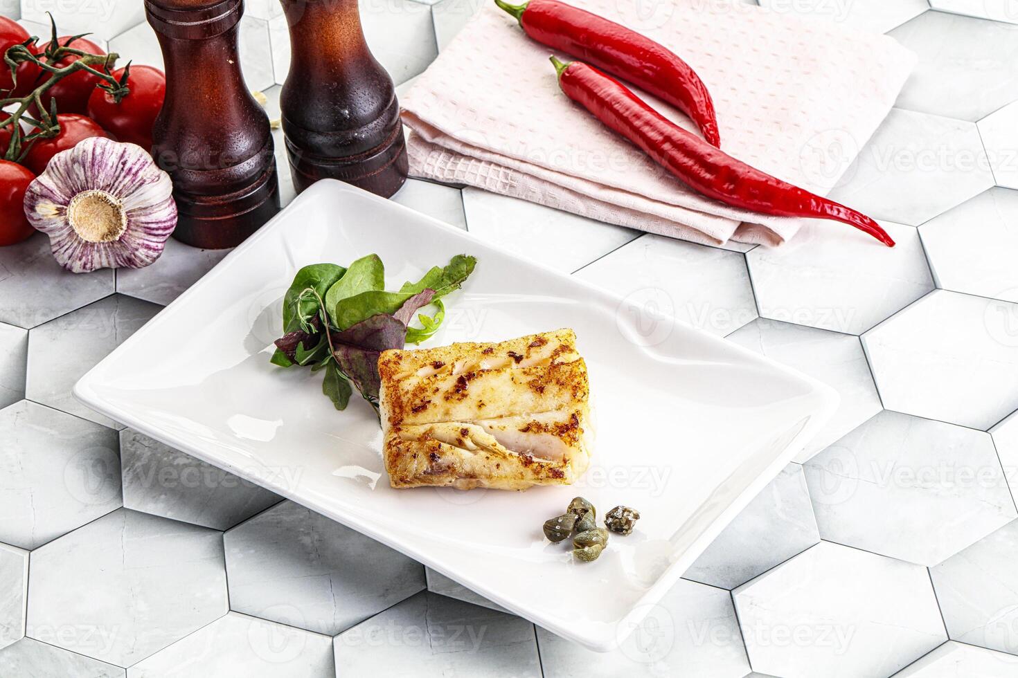 Roasted cod fish steak with salad photo