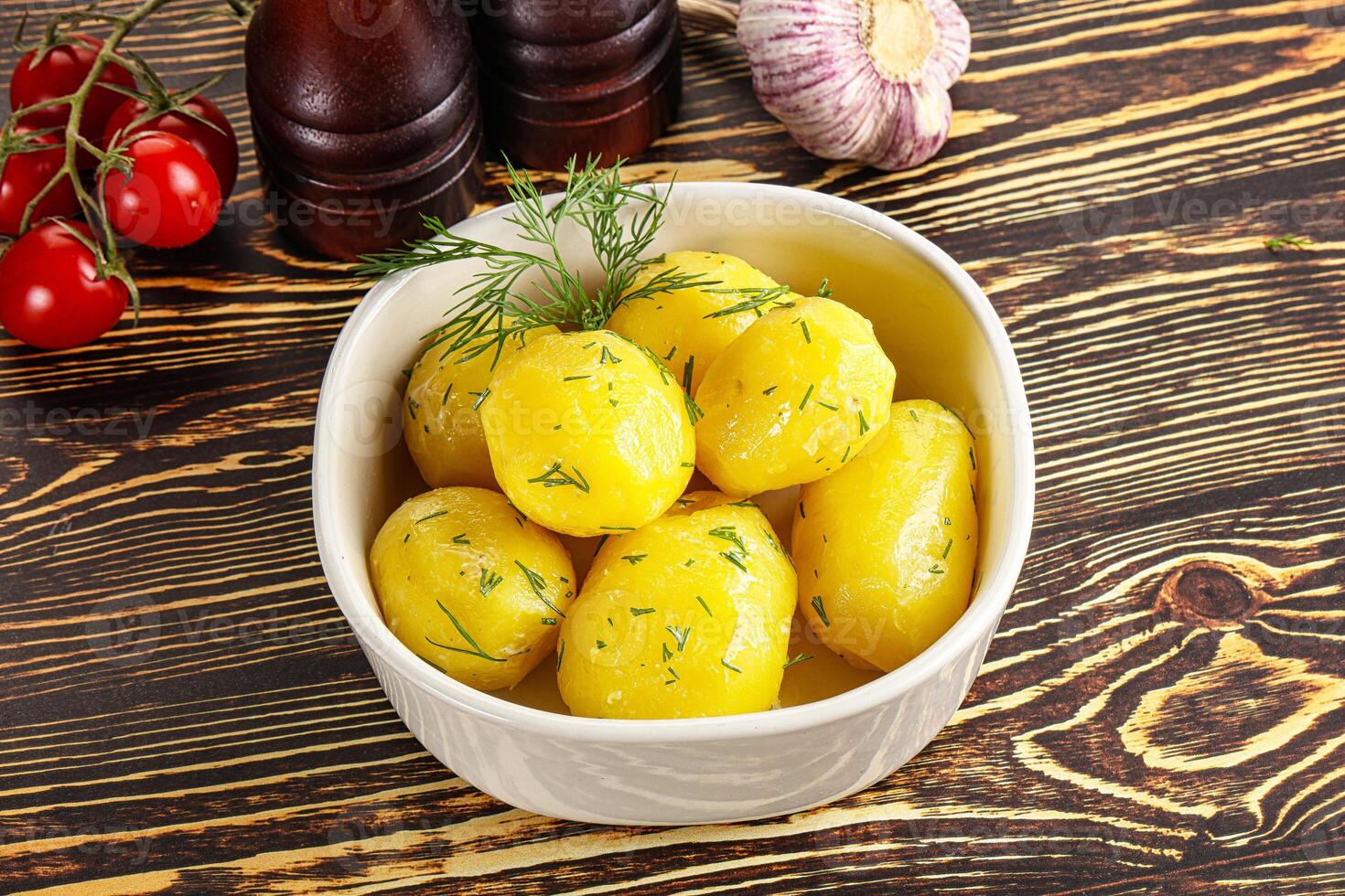 Boiled potato with oil and dill photo