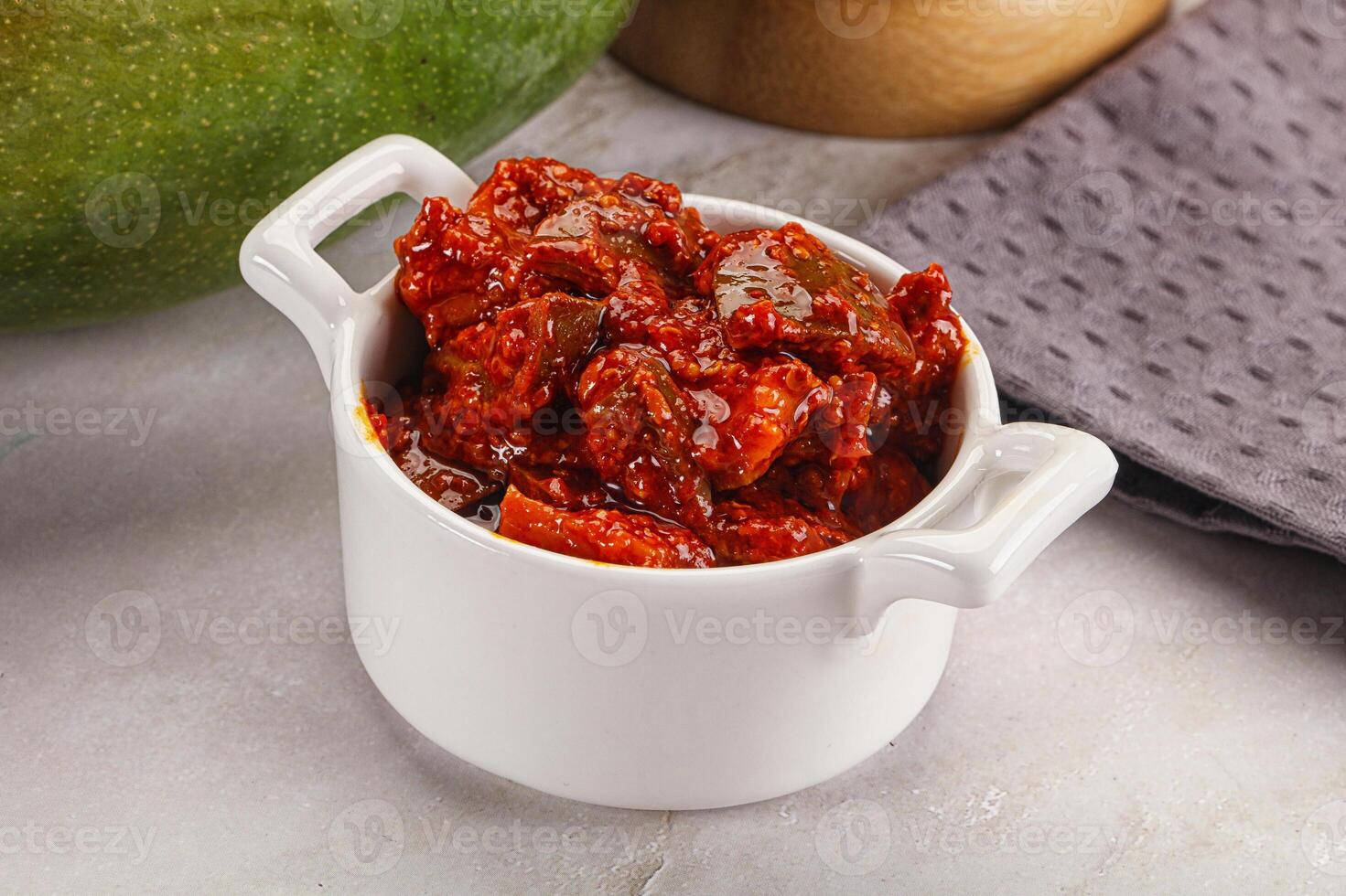 Spicy pickled raw green mango photo