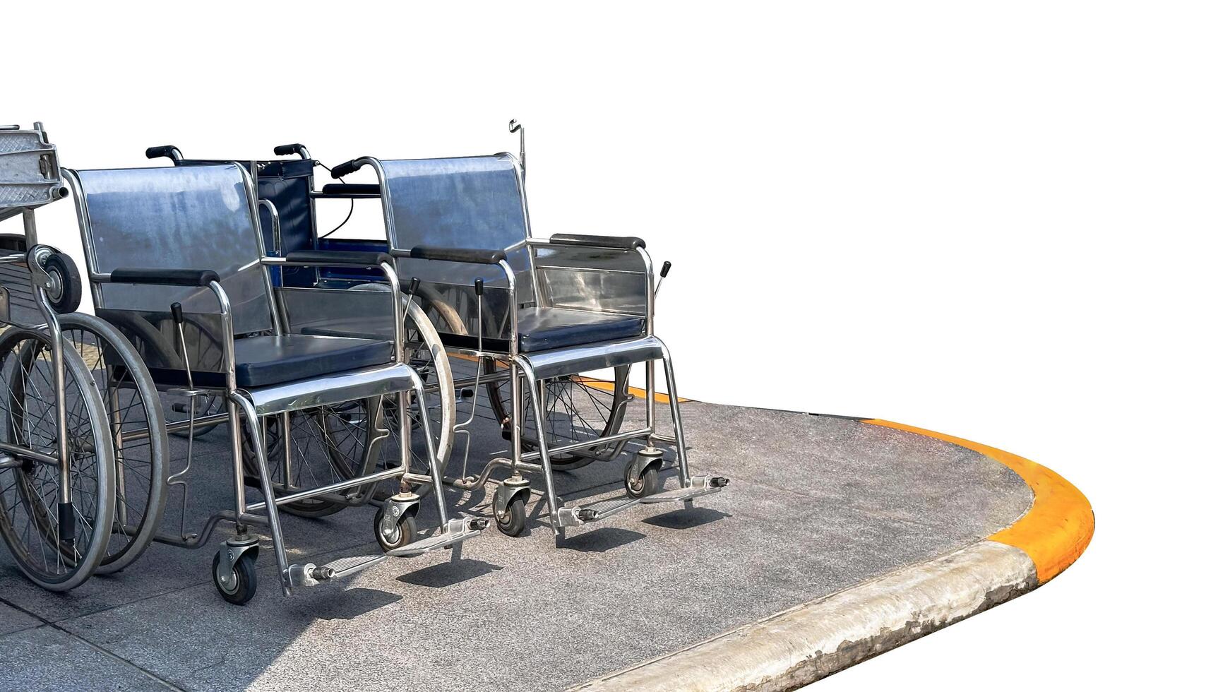 Isolated with clipping paths wheel chairs on dark gray footpath photo