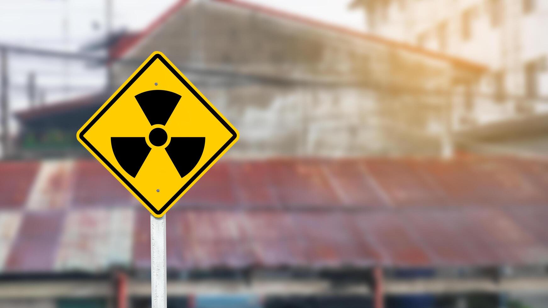 Yellow radioactive sign on blur background photo