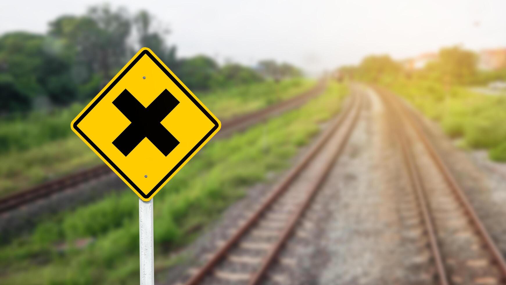 Train warning sign to warn people when crossing the train tracks photo