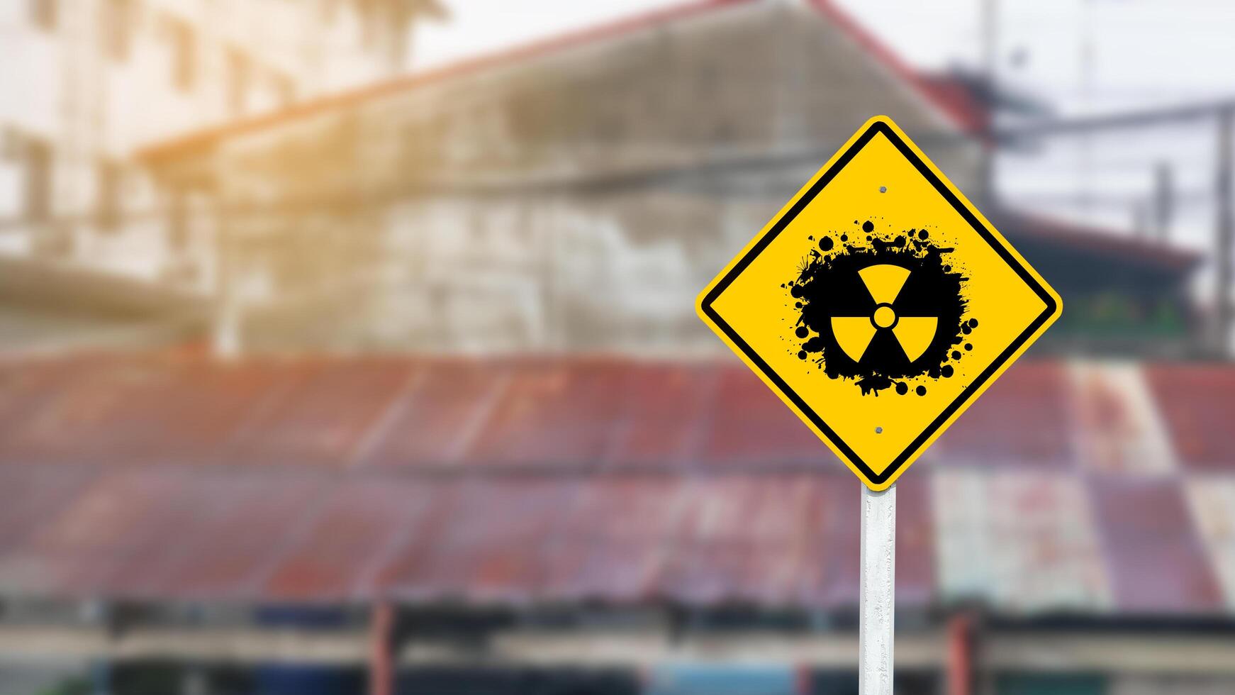 Yellow radioactive sign on blur background photo