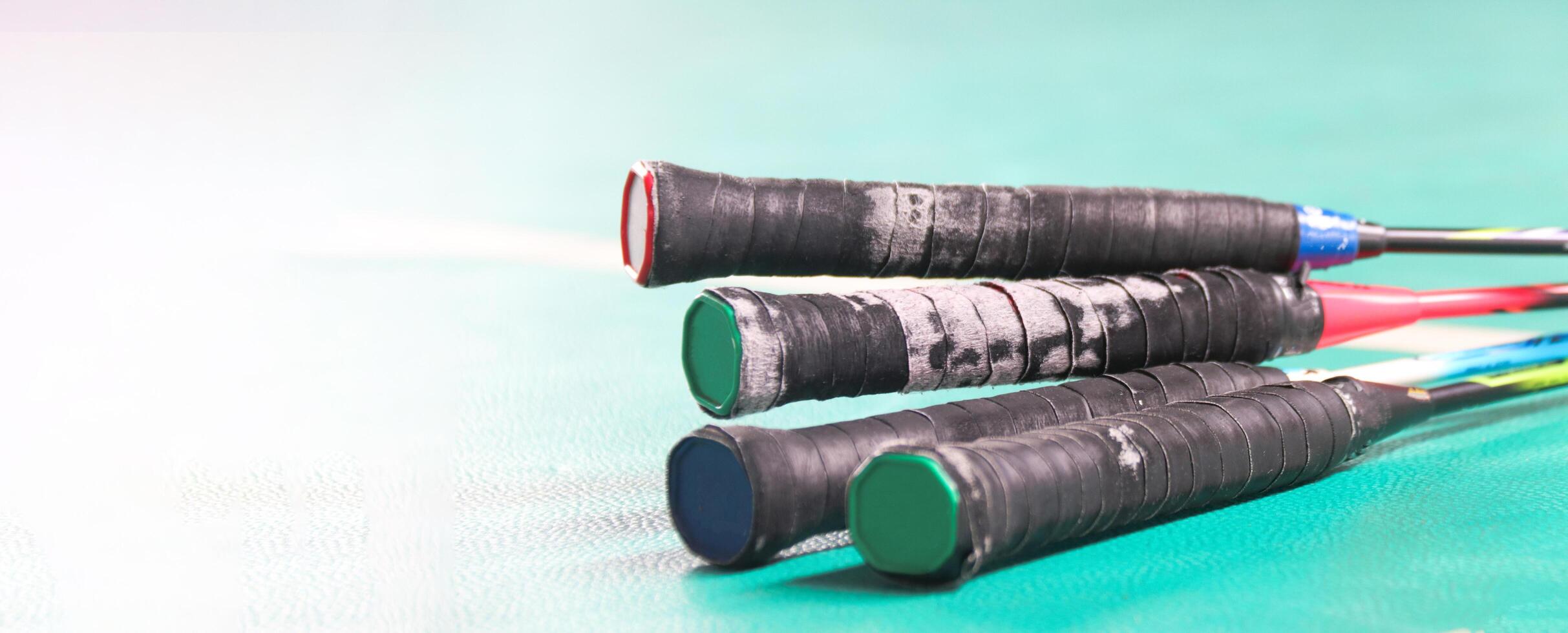 Close up badminton rackets handles in badminton court soft and selective focus photo