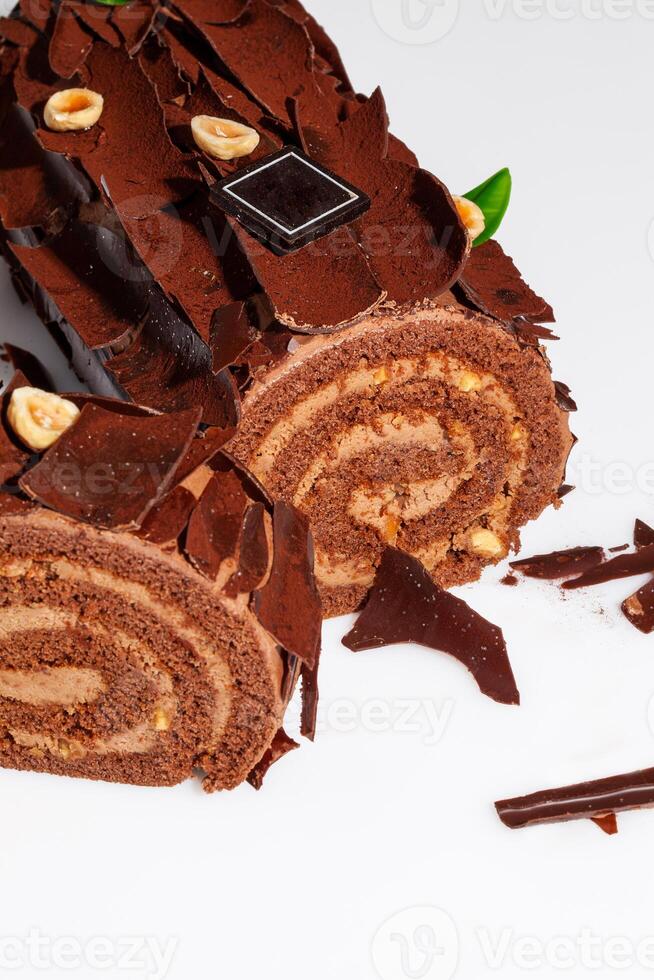 Sliced Swiss roll with buttercream, chocolate shavings and hazelnuts photo