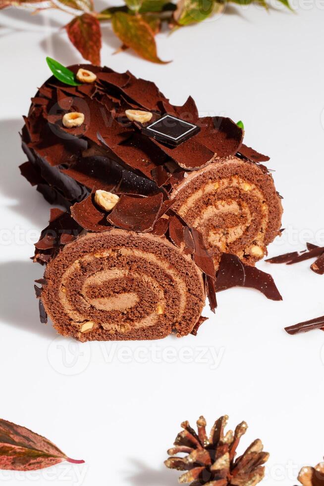 Sliced chocolate cake roll with buttercream and hazelnuts photo