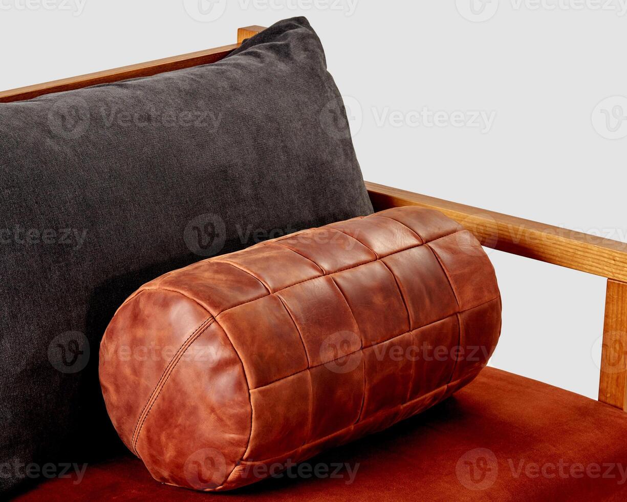 Comfortable copper-colored leather bolster cushion on soft sofa photo