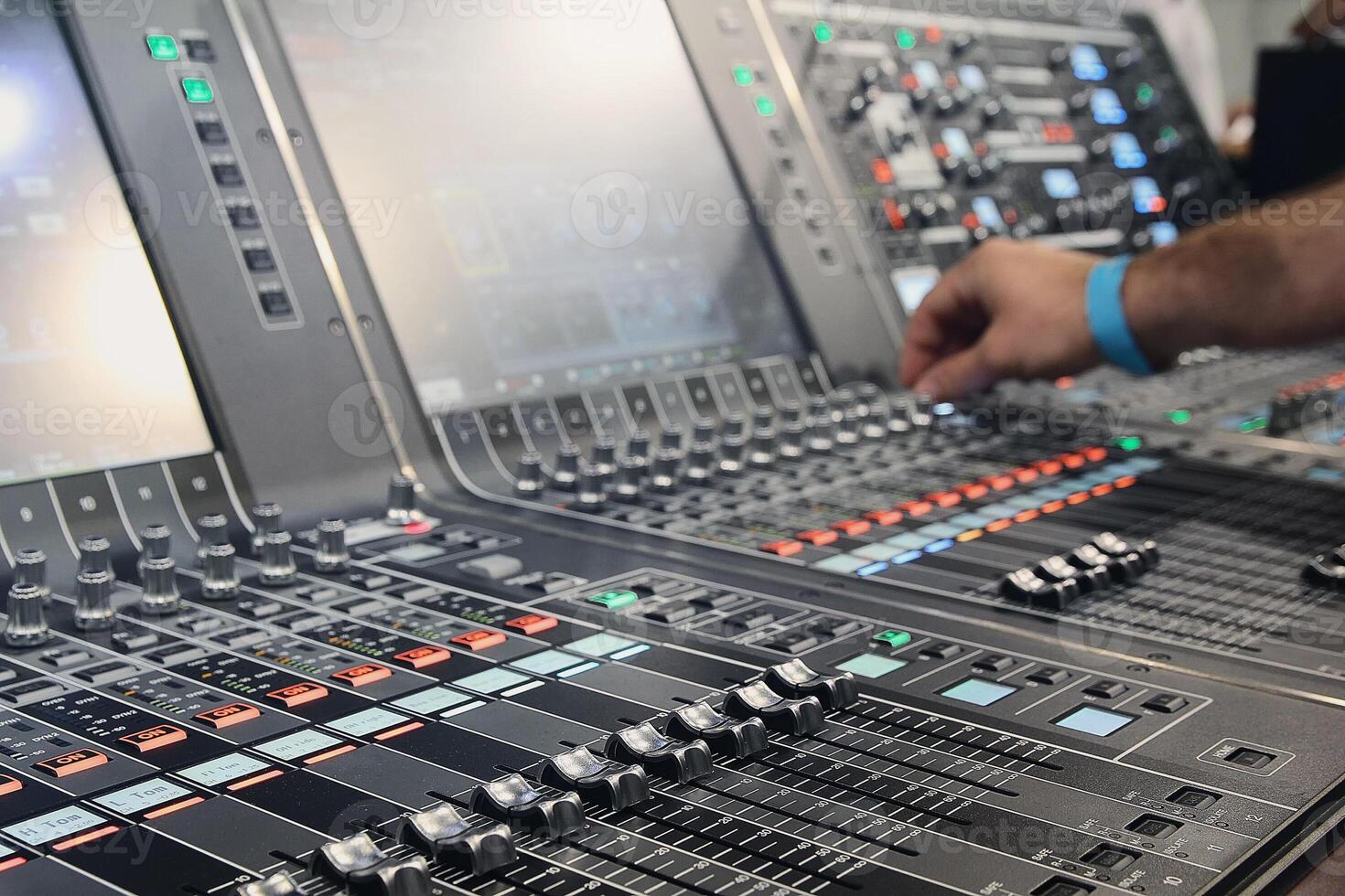 Sound engineer hands adjusting control sound mixer in recording, broadcasting studio photo