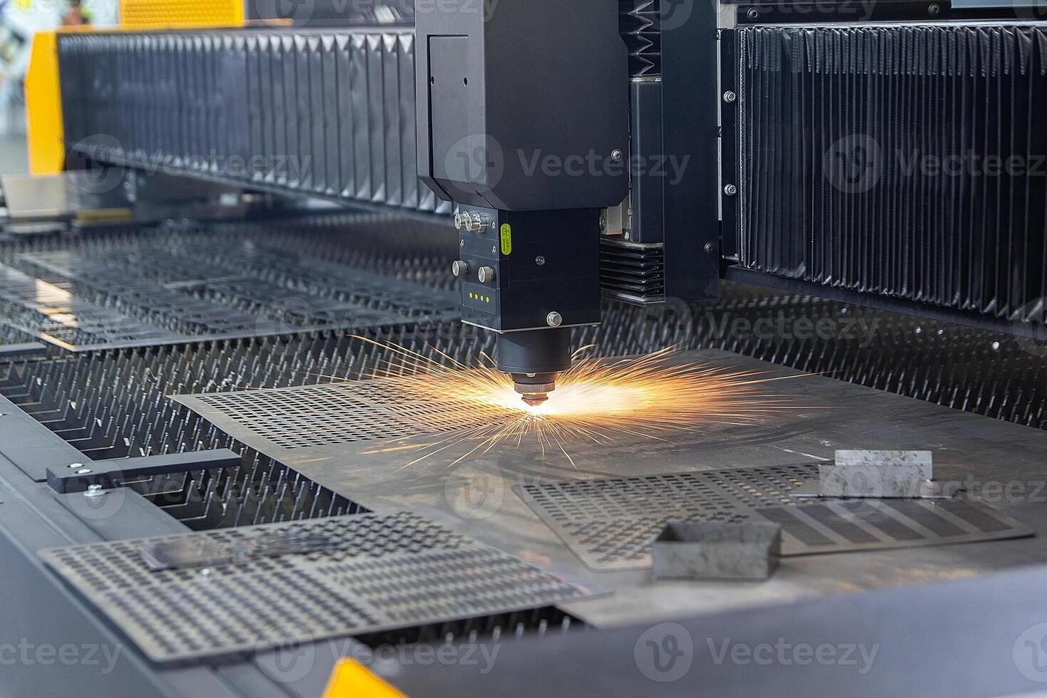 Laser cutting. Metal machining with sparks on CNC laser engraving maching photo