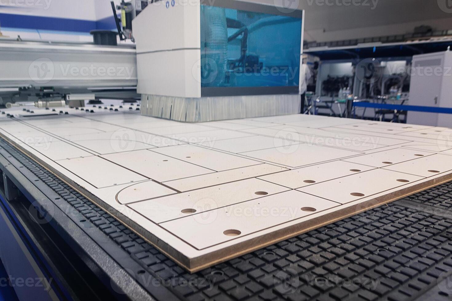 Modern machine for cutting chipboard at a furniture factory photo