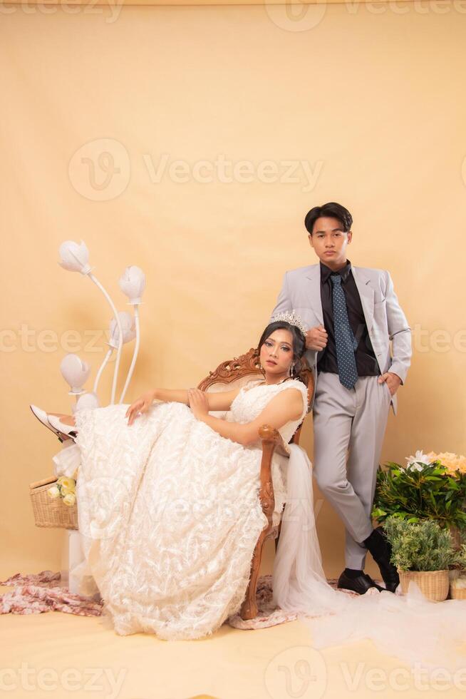 elegant male and female couple poses sitting standing relaxed smiling spoiled looking at the front intimately indoor photo shot. couple wedding national bride studio