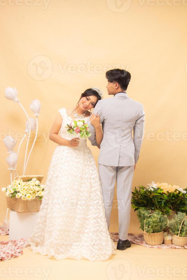 expressions of male and female couples standing poses casually laughing looking at the front of the woman and the man with their backs to each other intimately indoor photo shot. couple wedding