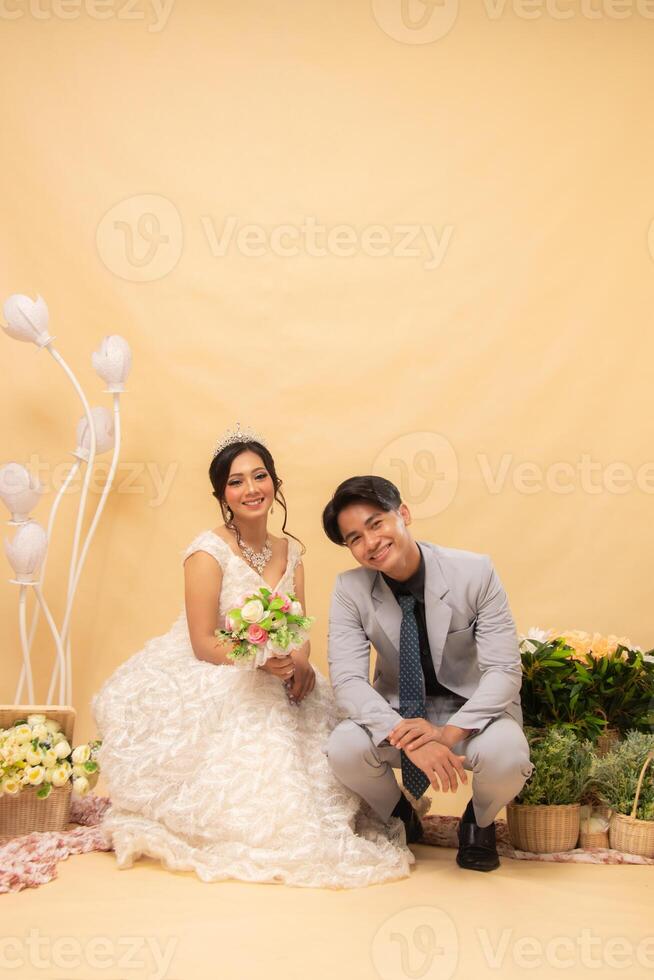 male and female couples sitting relaxed poses smiling at each other looking forward intimately indoor photo shot. couple wedding national bride studio