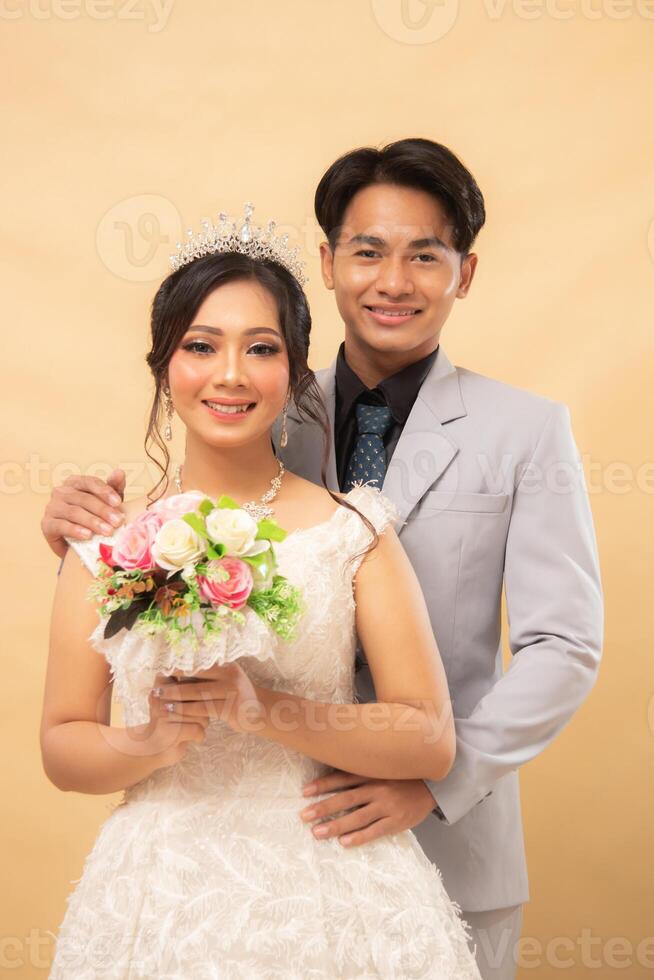 elegant male and female couple standing poses formal casual smiling slightly looking cheerful affectionate indoor photo shot closeup. couple wedding national bride studio