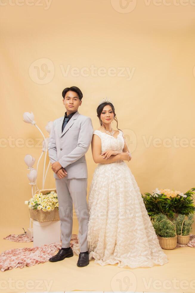 male and female couple expressions standing casually smiling at each other looking forward intimately indoor photo shot. couple wedding national bride studio