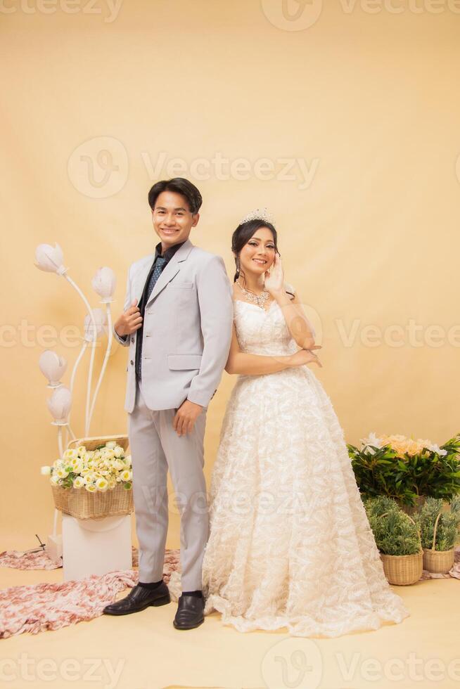 smile male and female couple expressions in formal poses standing relaxed laughing looking at each other intimately indoor photo shot. couple wedding national bride studio