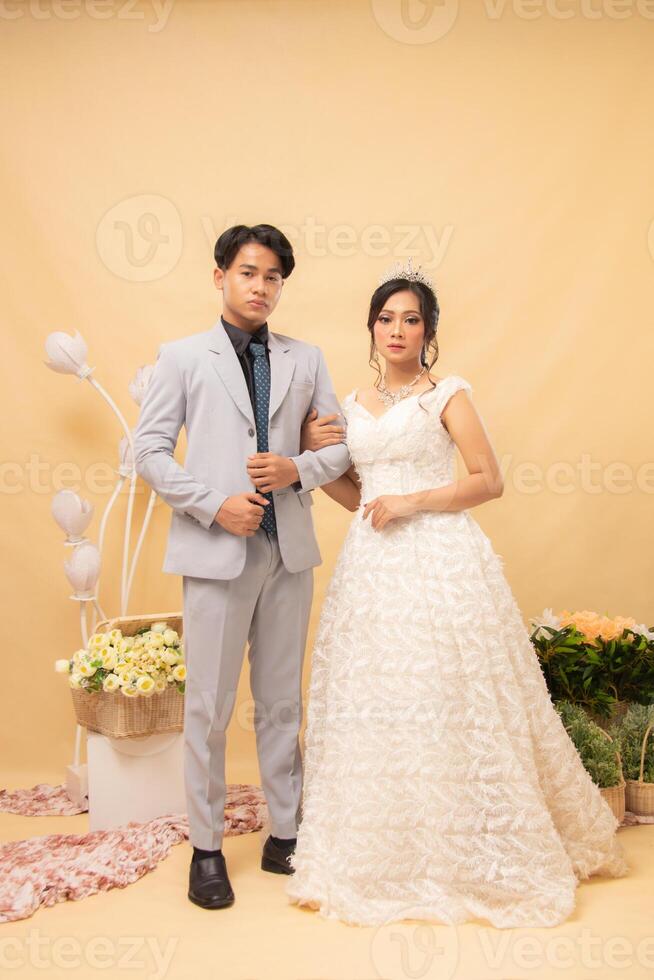 smile male and female couple expressions in formal poses standing relaxed laughing happy looking at each other intimately indoor photo shot. couple wedding national bride studio