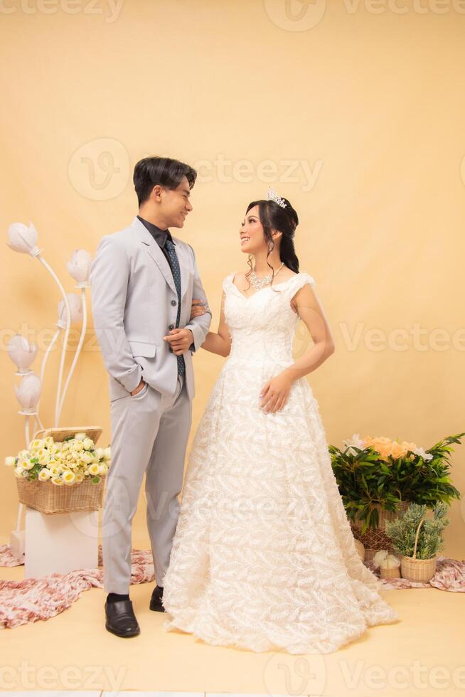 male and female couple expressions in formal poses standing casual smiling looking at each other intimately indoor photo shot. couple wedding national bride studio now