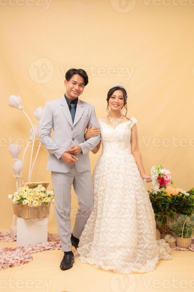 male and female couple walking poses smiling at each other in front of intimate indoor photo shot. couple wedding national bride studio