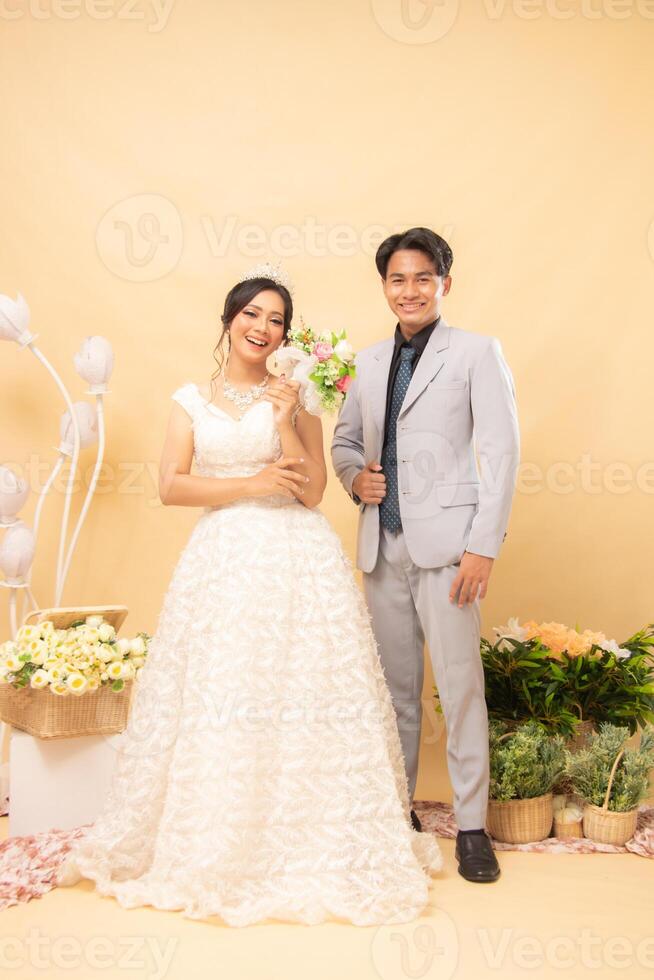 cheerful expression male and female couple in formal poses standing relaxed smiling smiling each other laughing looking forward intimately indoor photo shot. couple wedding national bride studio