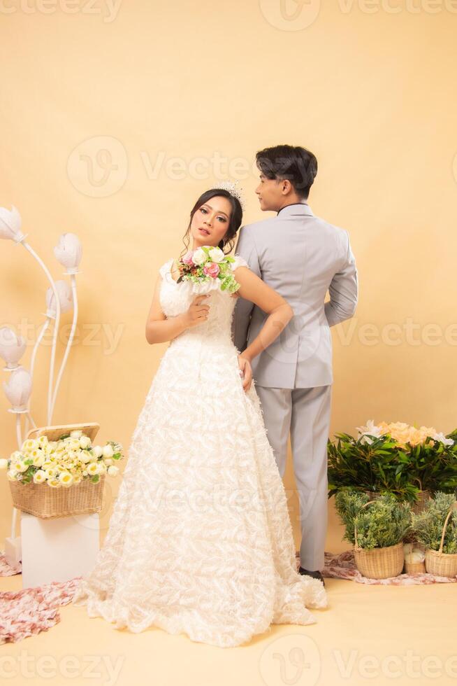 elegant of male and female couples standing poses casually laughing looking at the front of the woman and the man with their backs to each other intimately indoor photo shot. couple wedding