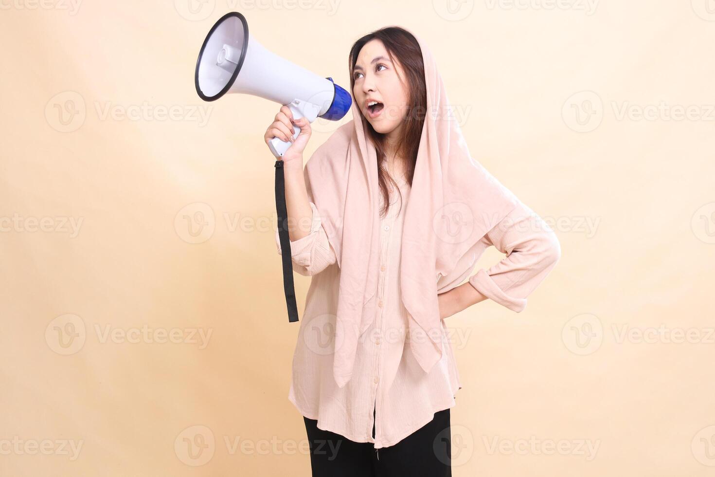 Asian woman carrying a megaphone loudspeaker shouting announcements of shopping promotions. beautiful women for business, technology, fashion photo