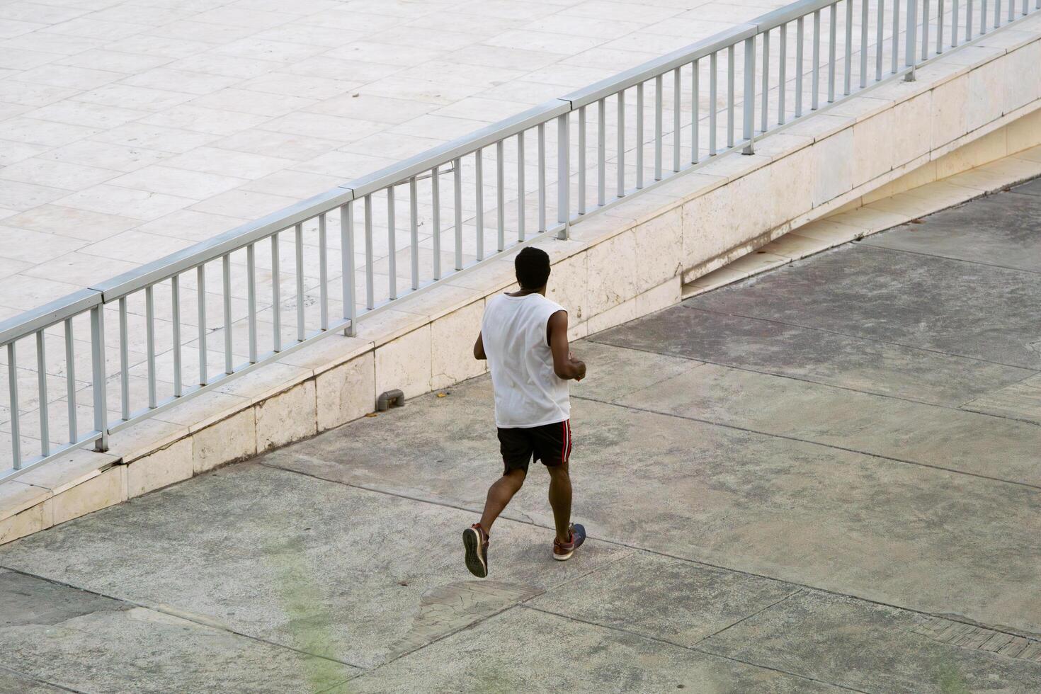 Jakarta, Indonesia, 2024 - Morning Exercise, Running Man in Lapangan Banteng Wearing Jersey photo