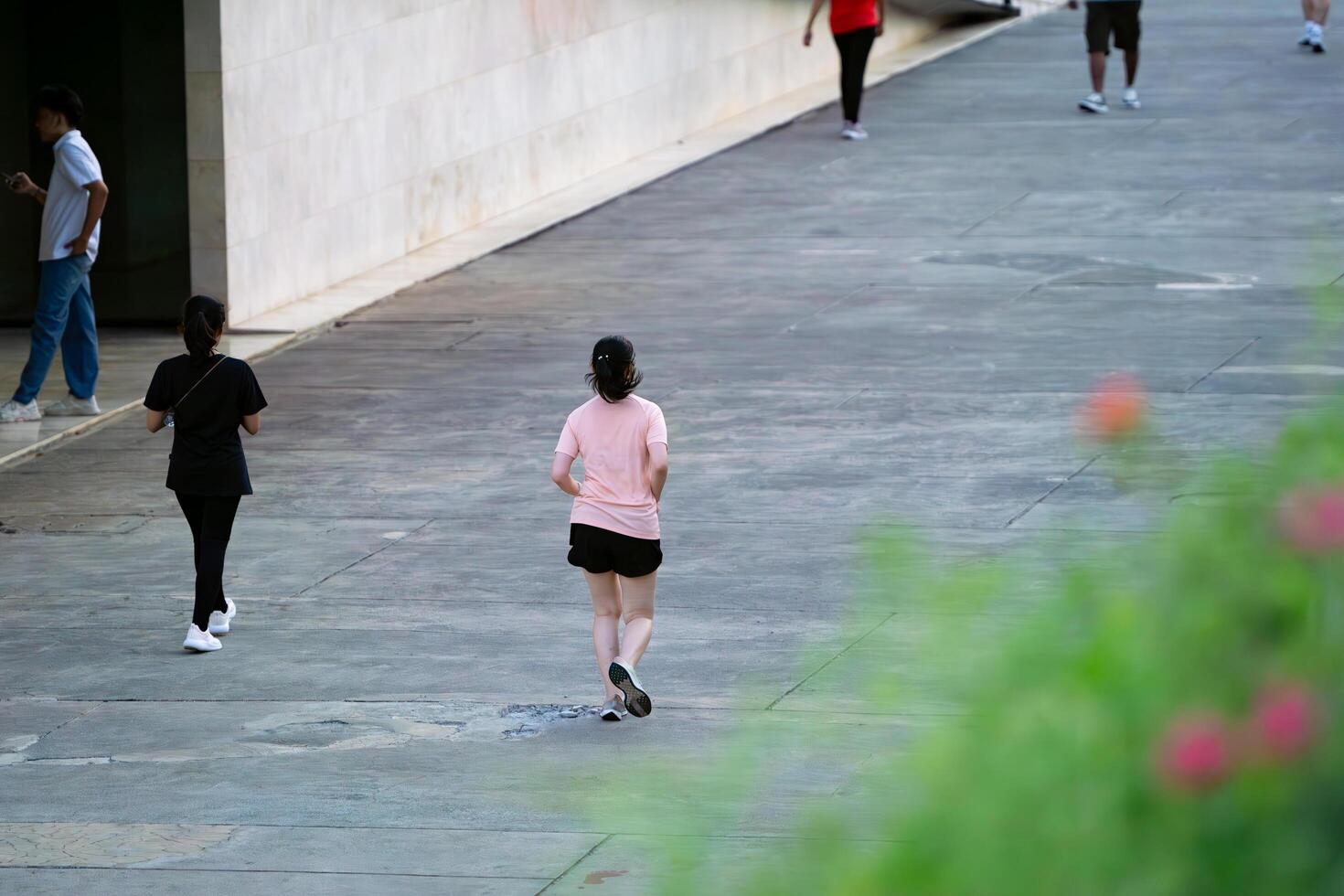 Jakarta, Indonesia, 2024 - Woman Jogging in Lapangan Banteng Park in Morning Workout Routine photo