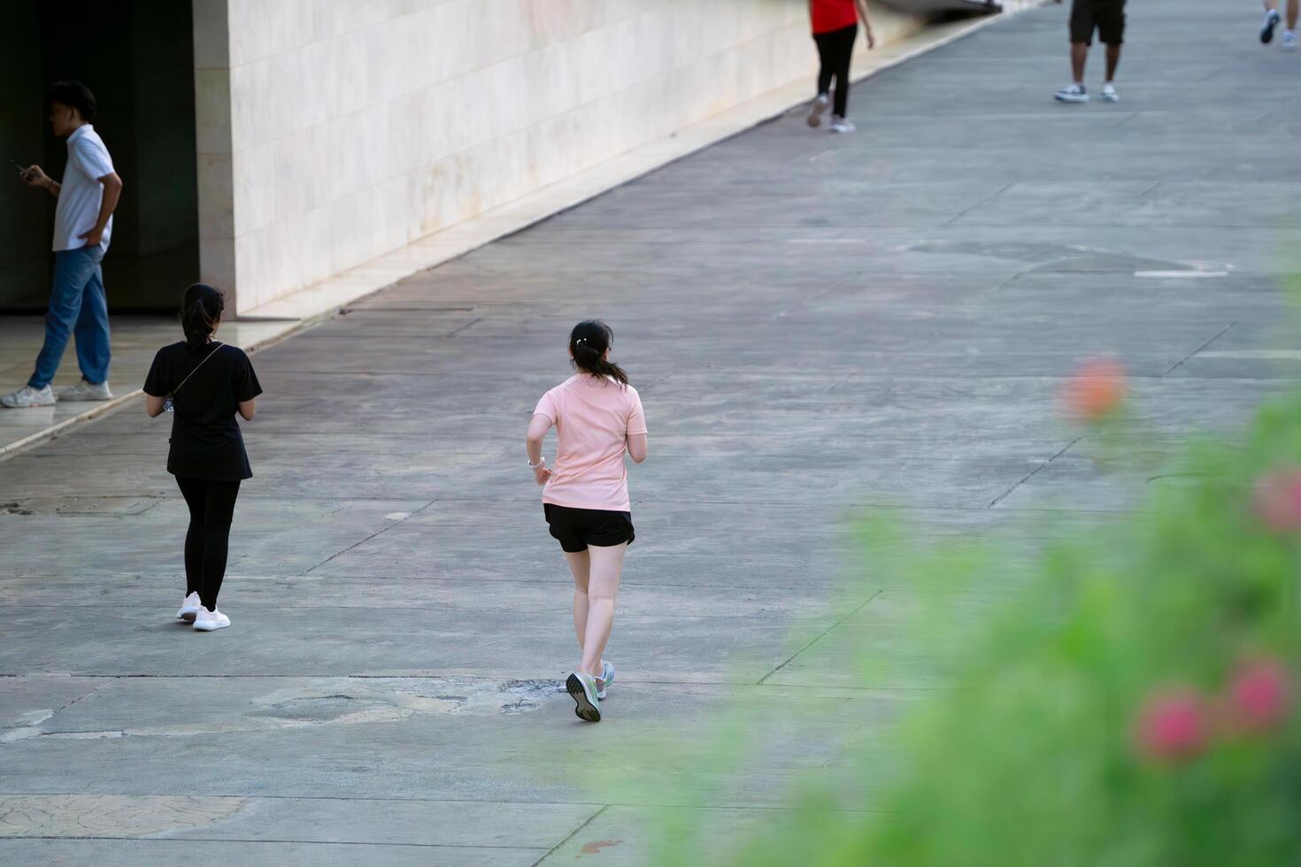 Jakarta, Indonesia, 2024 - Woman Jogging in Lapangan Banteng Park in Morning Workout Routine photo