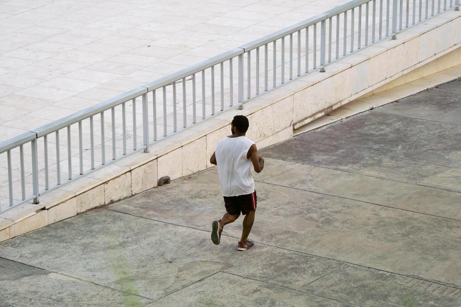 Jakarta, Indonesia, 2024 - Morning Exercise, Running Man in Lapangan Banteng Wearing Jersey photo