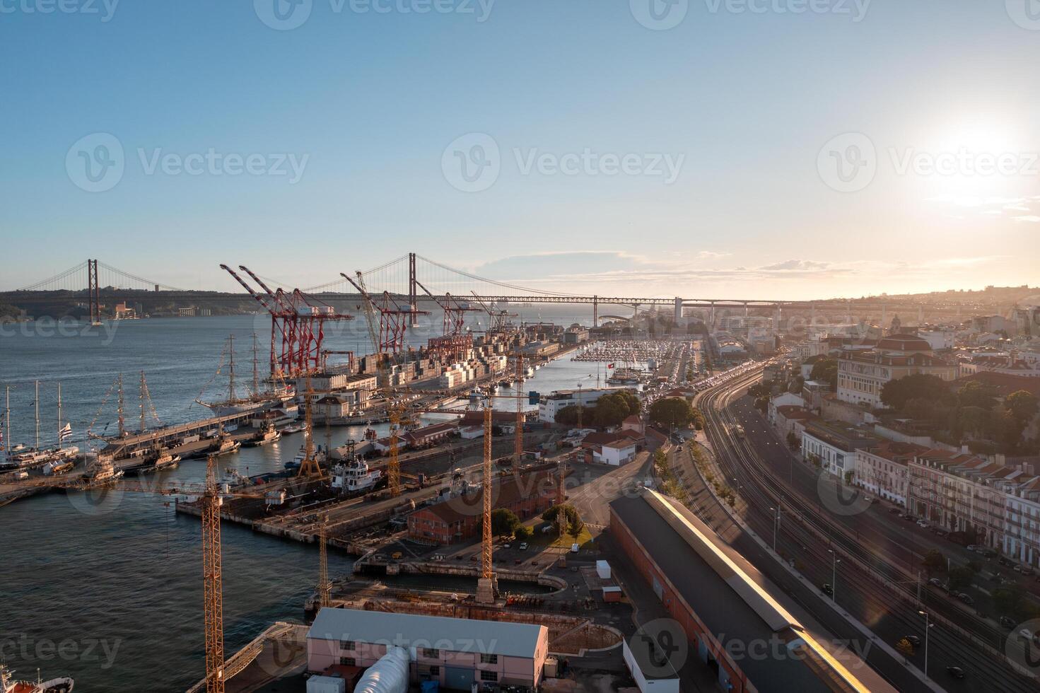 Harbor with bridge under cloudy sky, overlooking urban landscape by water photo