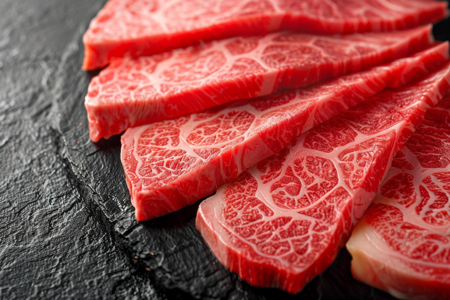 Raw Marbled Beef Slices on Black Plate. photo