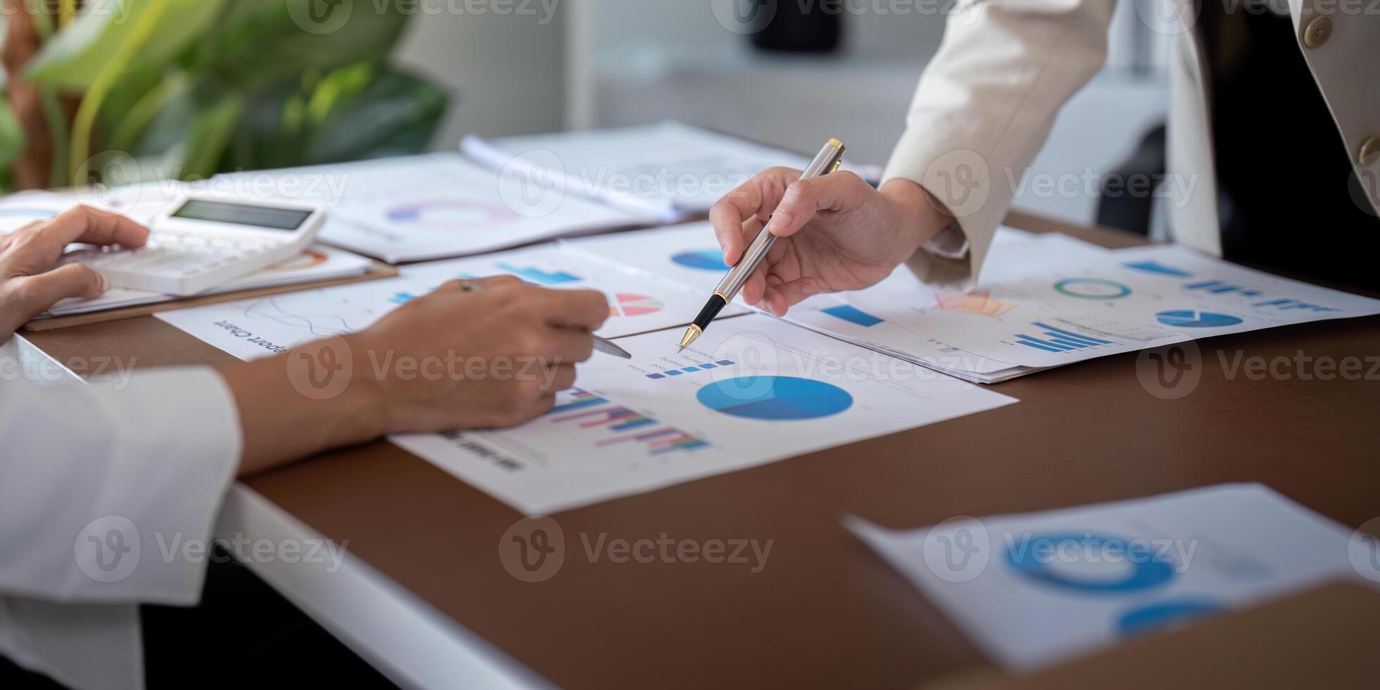 Business professionals discussing financial data and charts in an office. Concept of teamwork, strategy, and data analysis photo