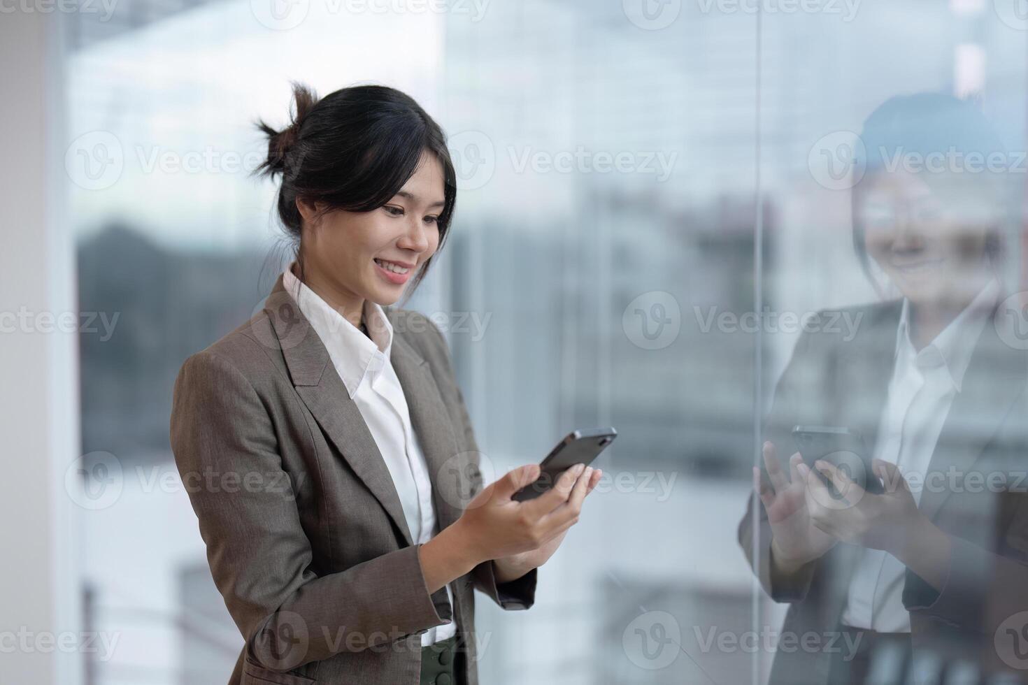 Business woman asian happy businesswoman use smartphone in office photo