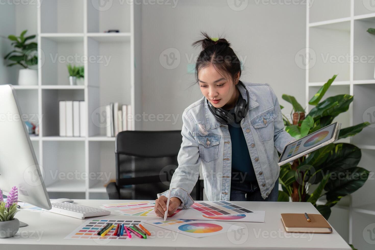 UX designer. Work on creative applications. Man with a palette in his hands. Designer applies the primary colors to the monitors. Development of a training application. Designer is a freelancer photo