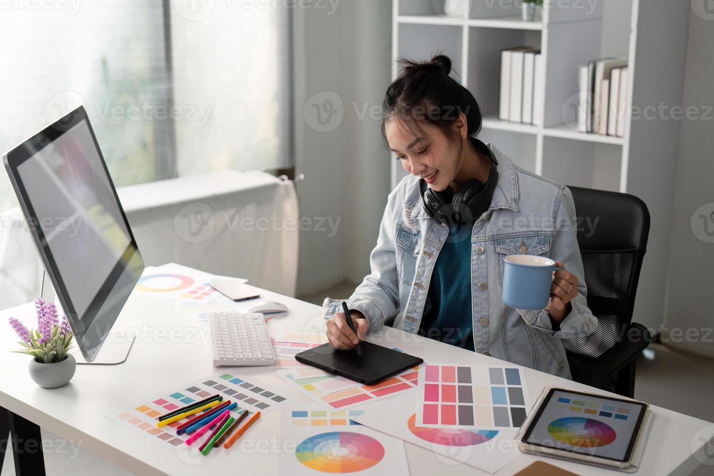 UX designer. Work on creative applications. Man with a palette in his hands. Designer applies the primary colors to the monitors. Development of a training application. Designer is a freelancer photo