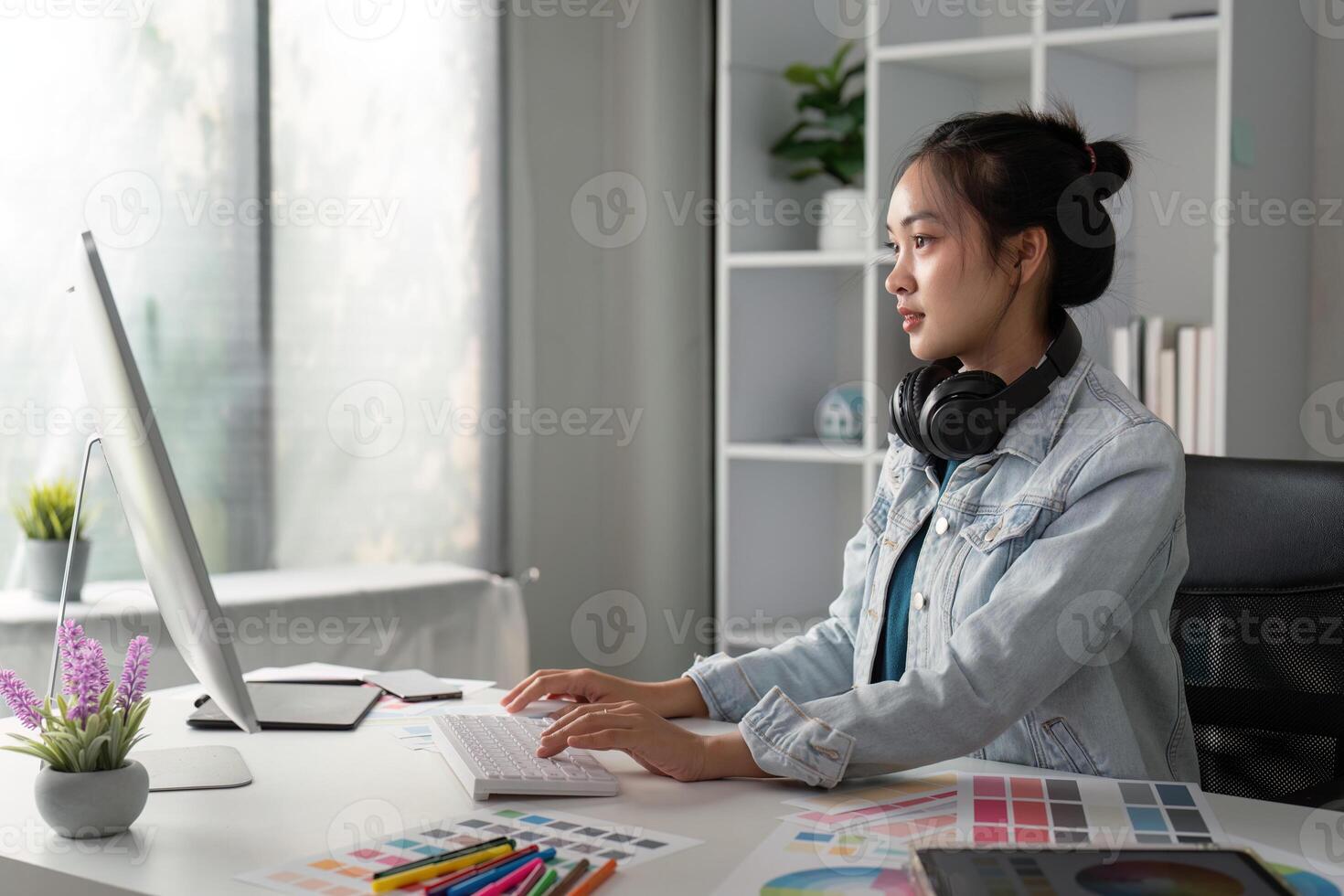 UX designer. Work on creative applications. Man with a palette in his hands. Designer applies the primary colors to the monitors. Development of a training application. Designer is a freelancer photo