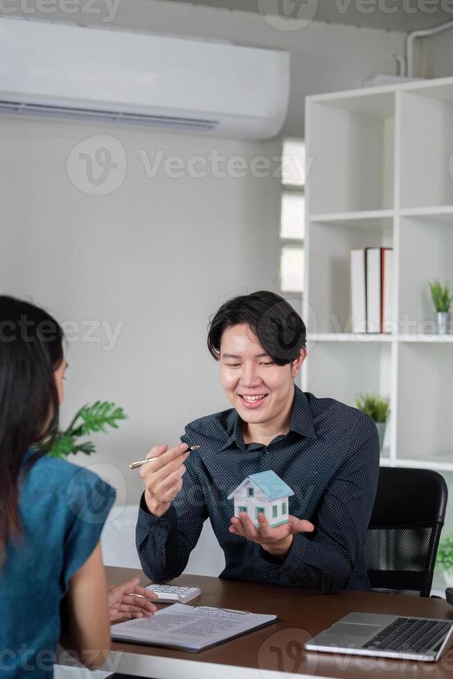 Real Estate Agent Signing Documents with Client for Buy or Sell Property in Modern Office Setting photo