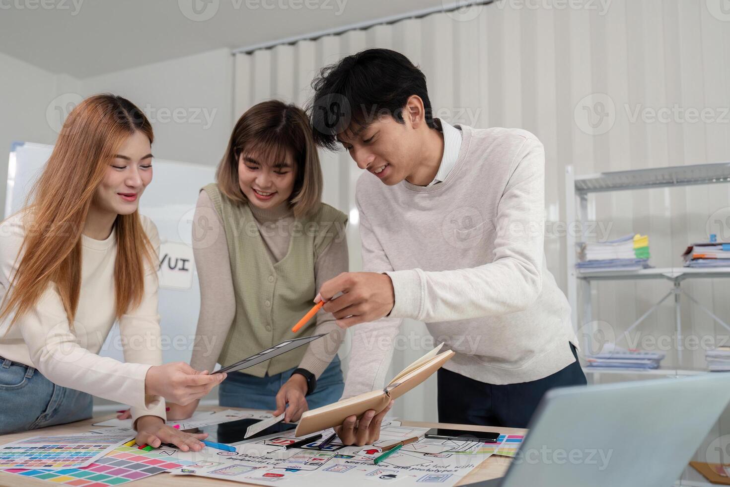Creative UX Developer and UI Designer Team Brainstorming Innovative Ideas in Modern Office Environment photo